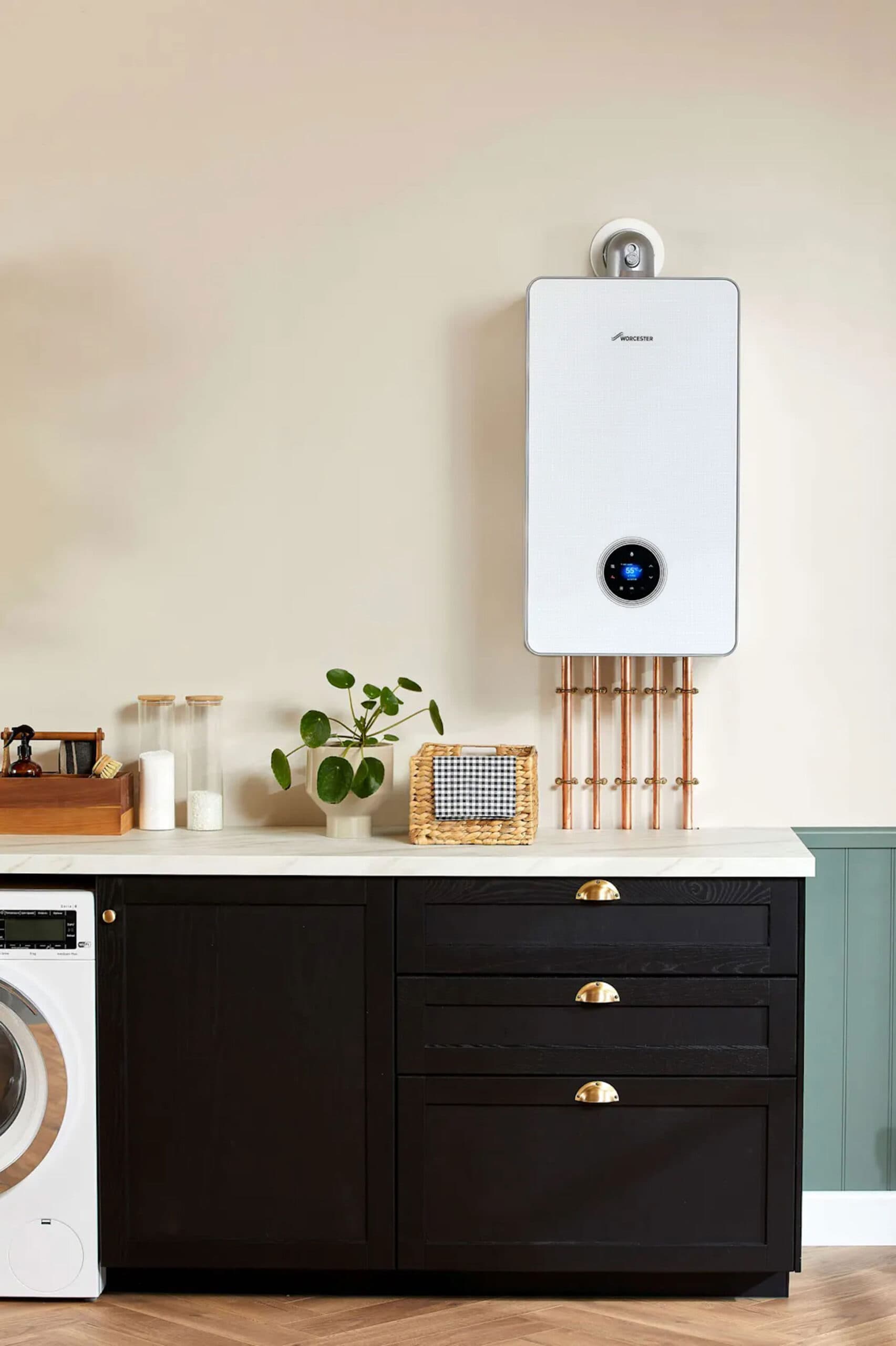 A wall-mounted boiler above a kitchen work surface