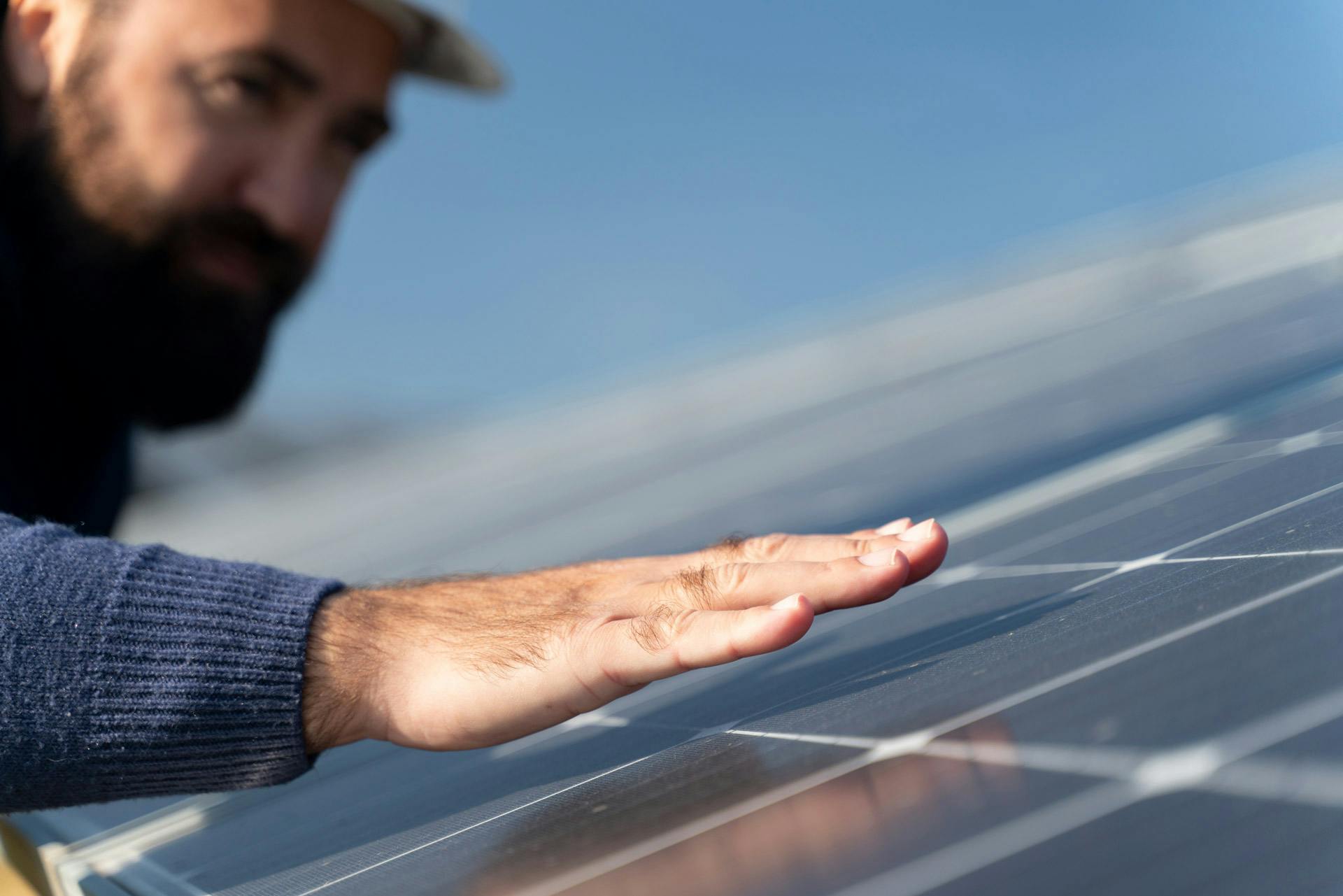 A man putting his hand on top of his solar panels