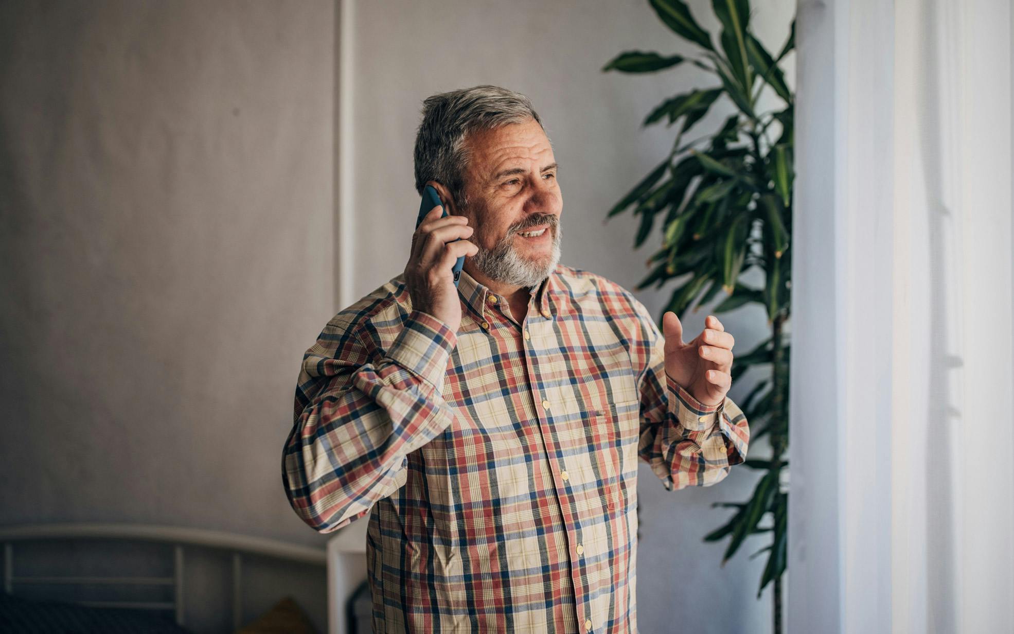 A man discussing solar panels on a phone call with a Utilita Home Energy Consultant.