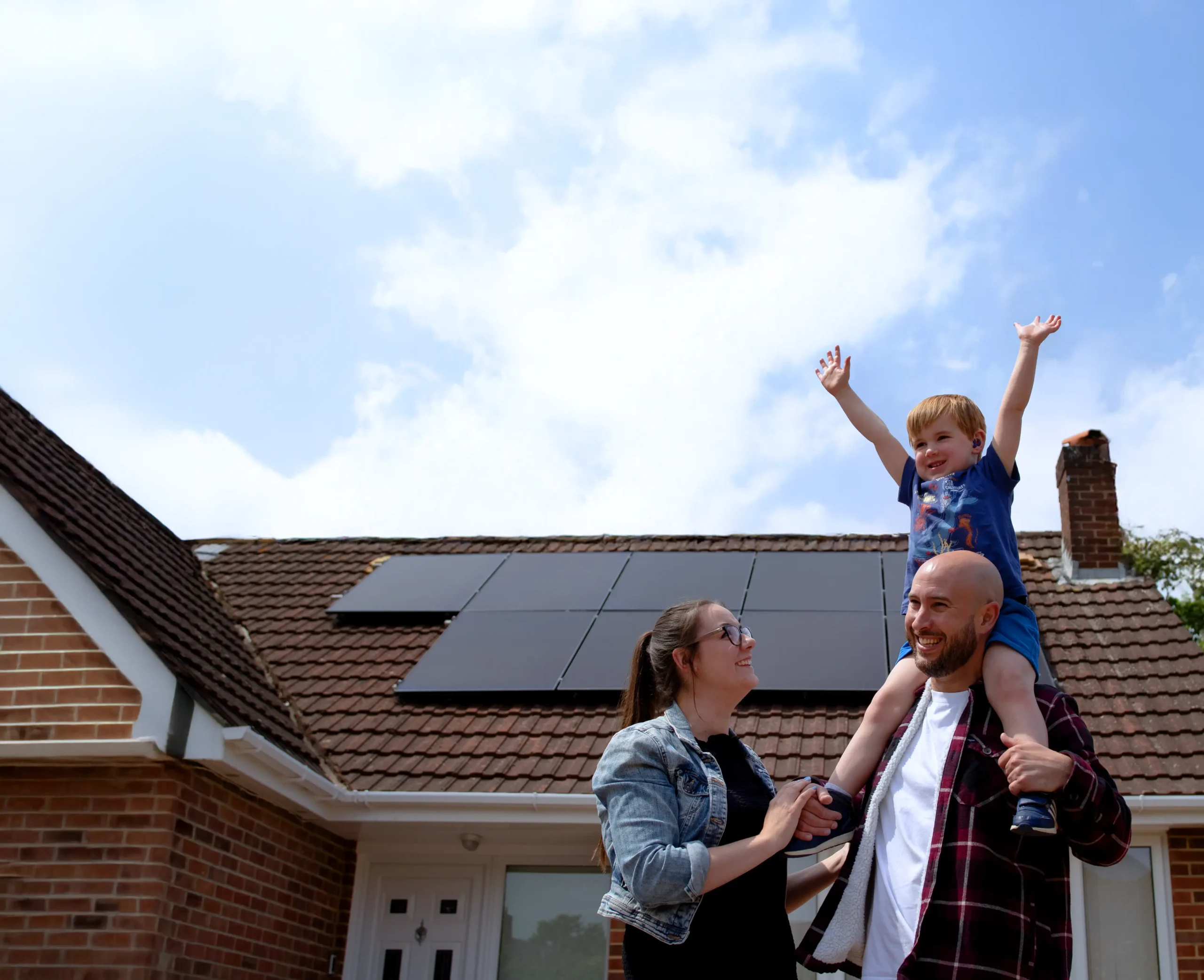 Image of home solar panels & a happy family saving money on bills & enjoying life with solar from Utilita Home.