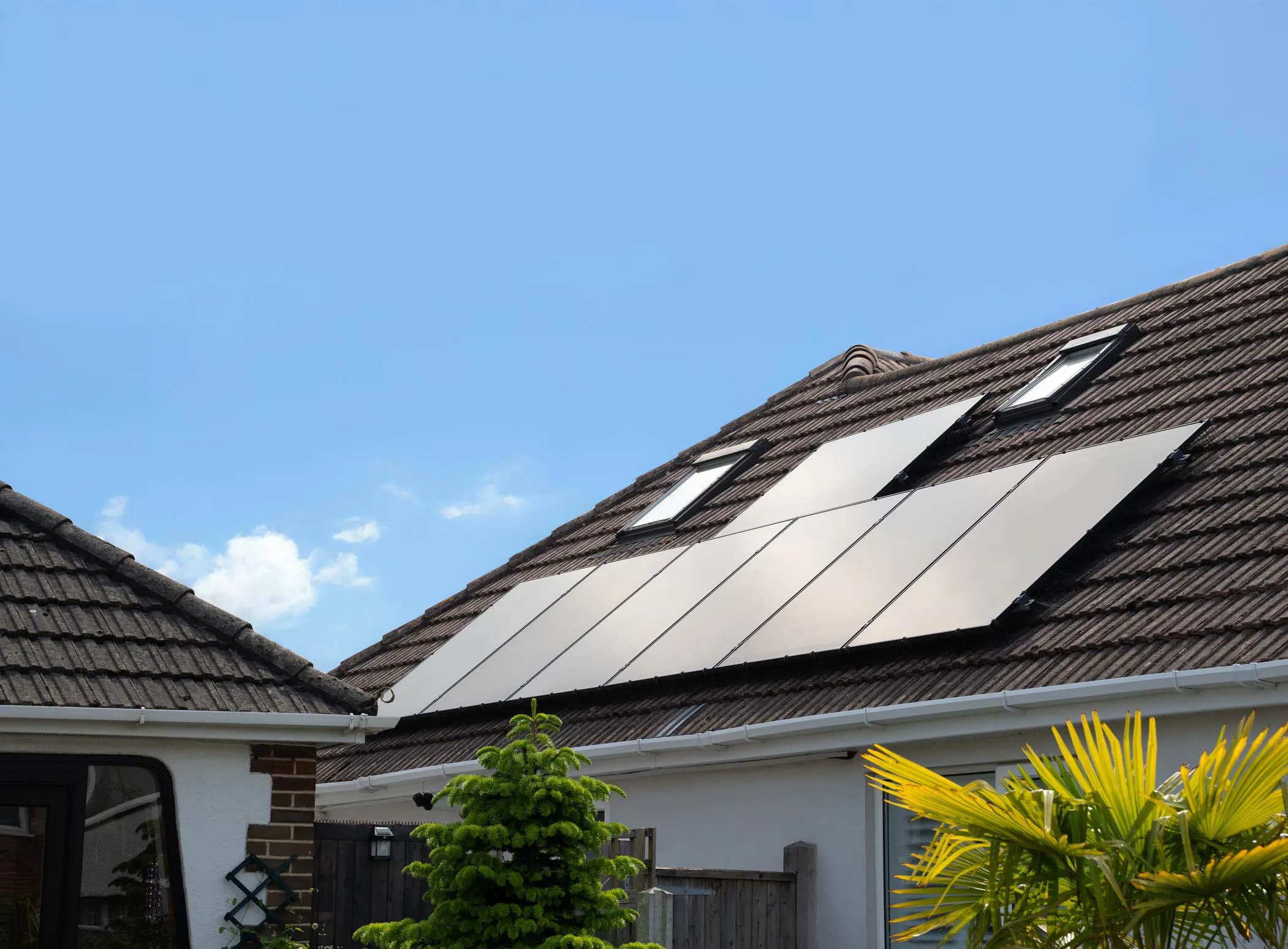 Rooftop solar panels installed on a house on a sunny day, symbolising Utilita Home's solar referral scheme offer.