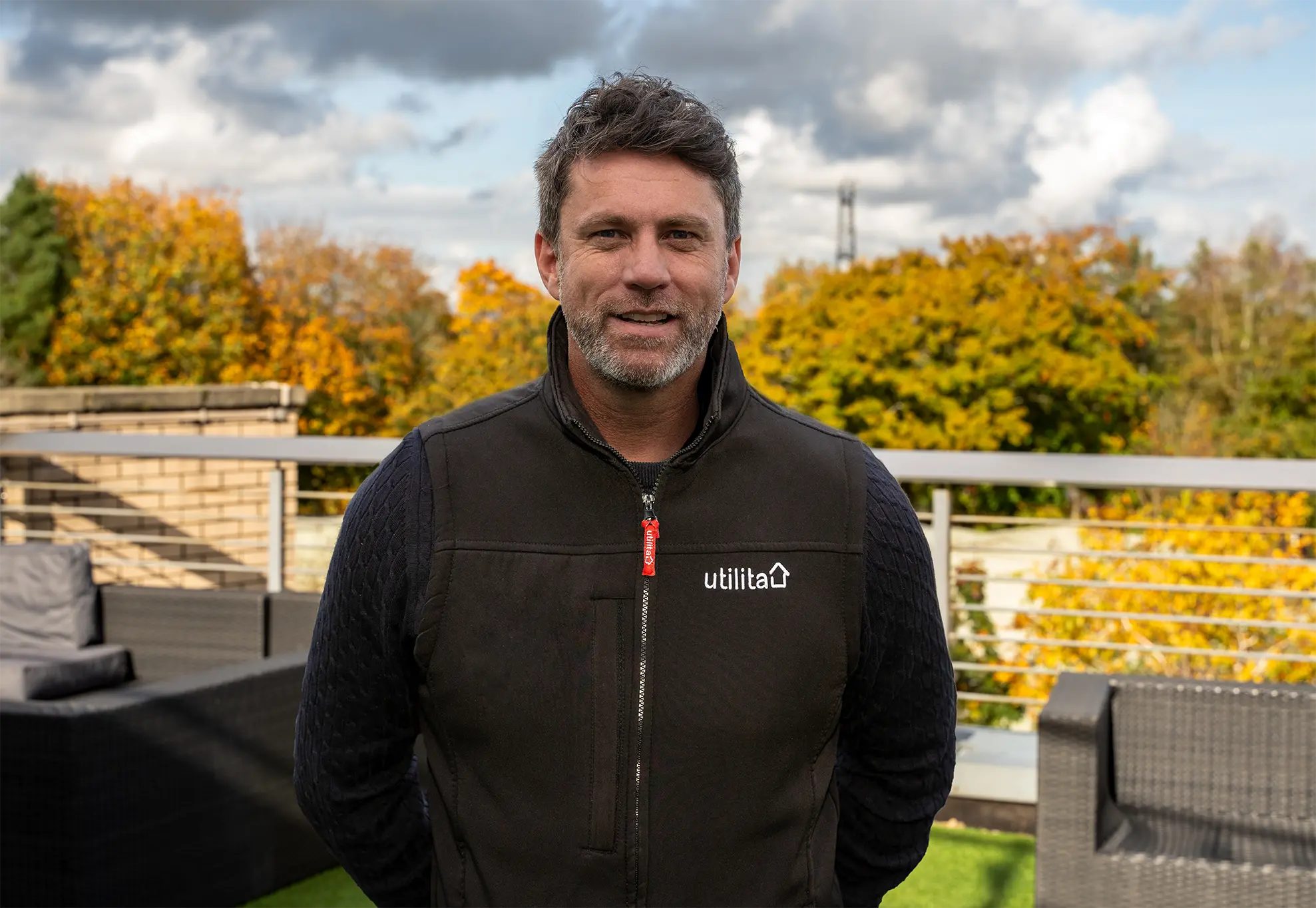 Photo of Tom Hickey, Utilita Home's, Solar PV & Storage Manager, stood outside with trees in the background.