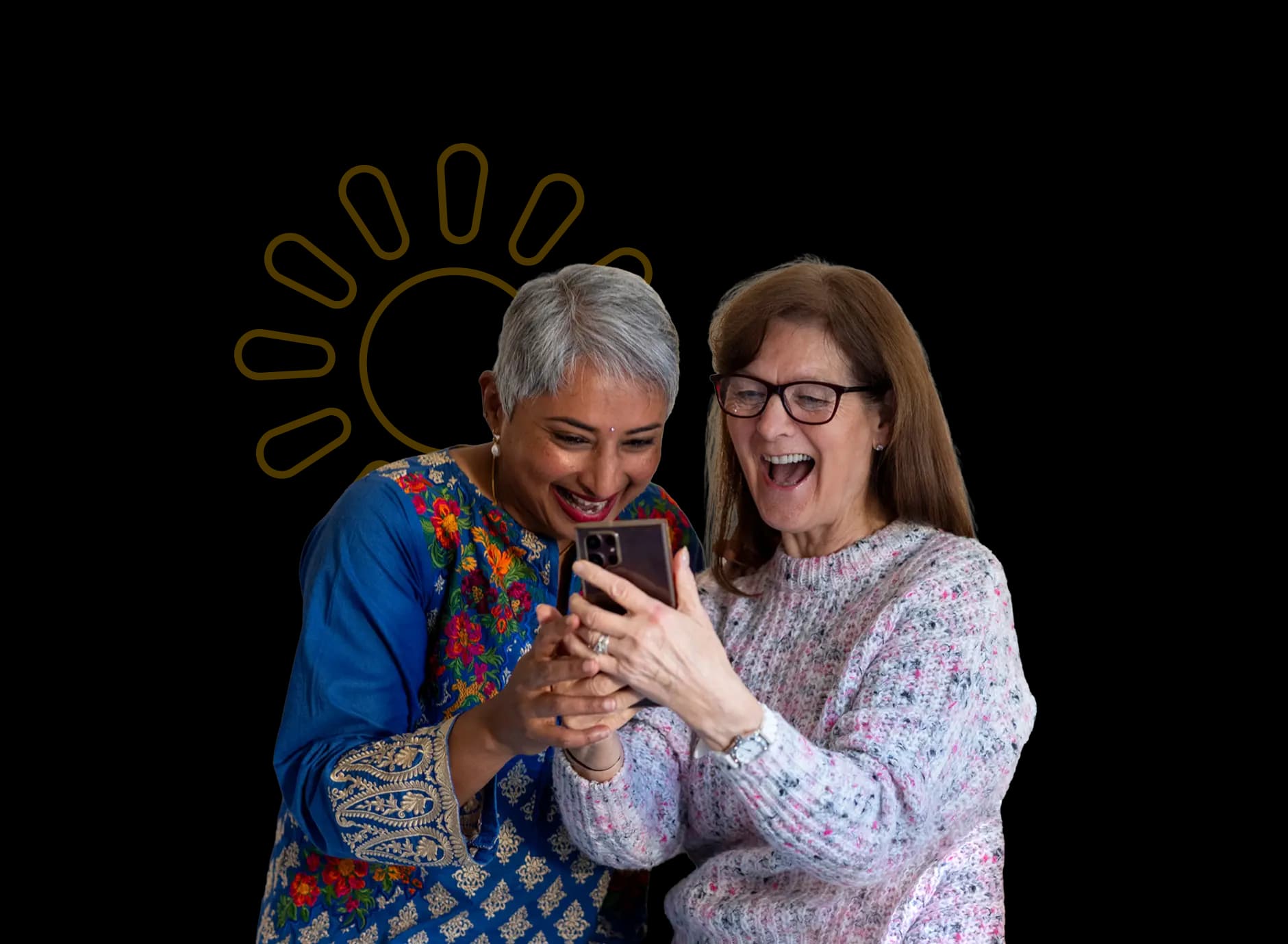 Two women laughing while looking at a mobile phone after earning £150 through Utilita Home's solar referral scheme.