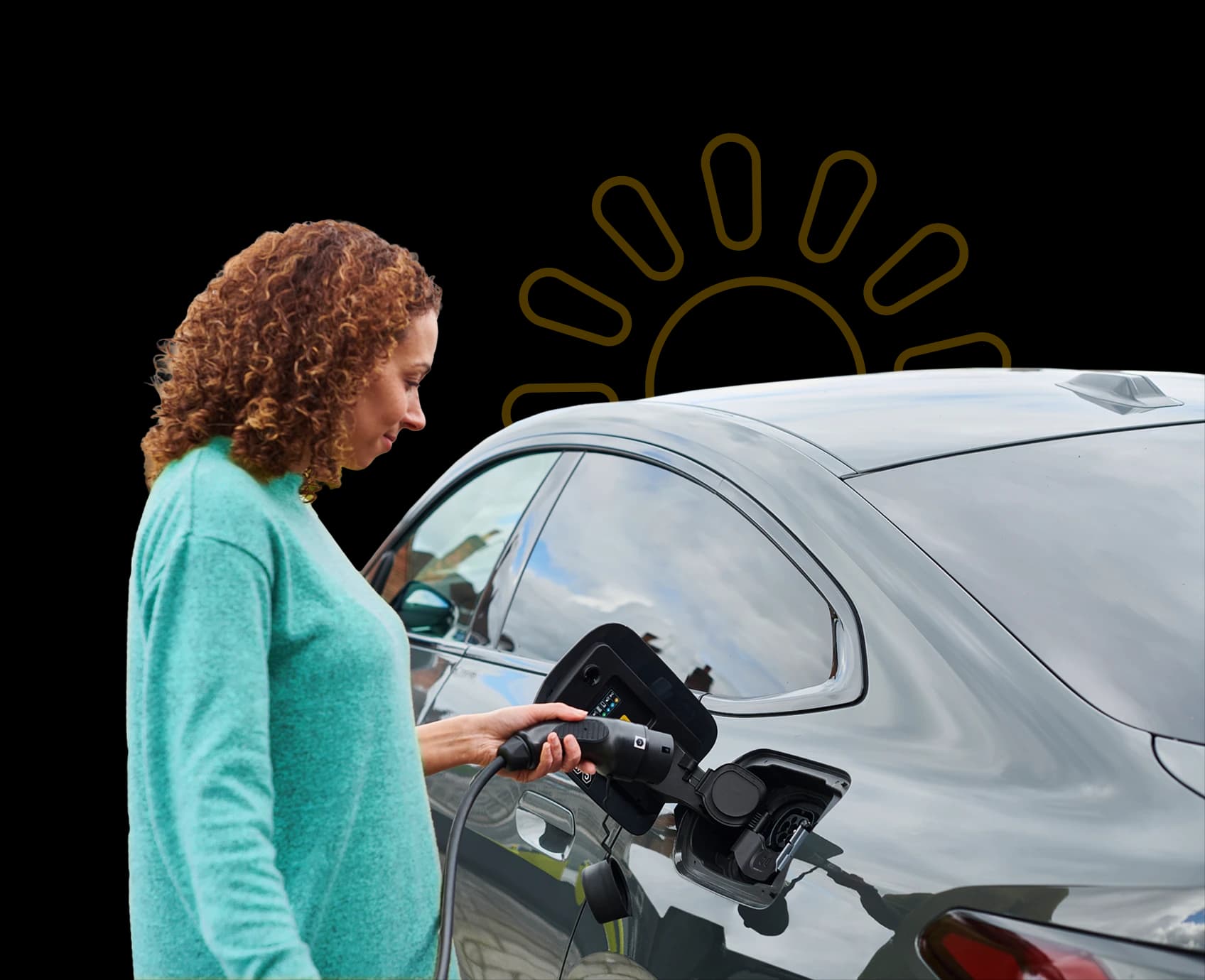 Woman plugging an Ohme EV Charger into her car to charge using the energy generated from her Utilita Home solar panels.